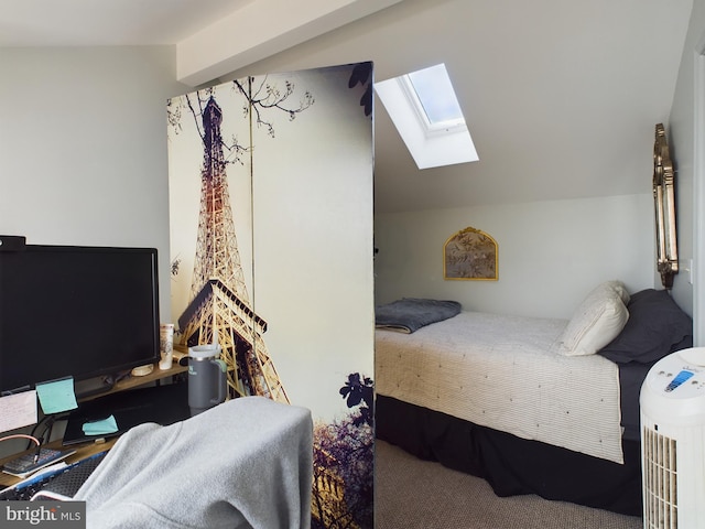 carpeted bedroom featuring vaulted ceiling with skylight