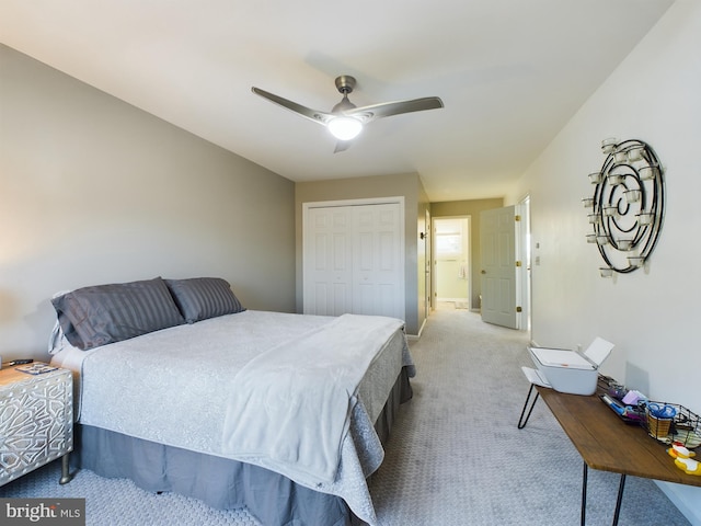 carpeted bedroom with a closet and ceiling fan