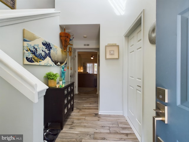 hallway with light hardwood / wood-style floors