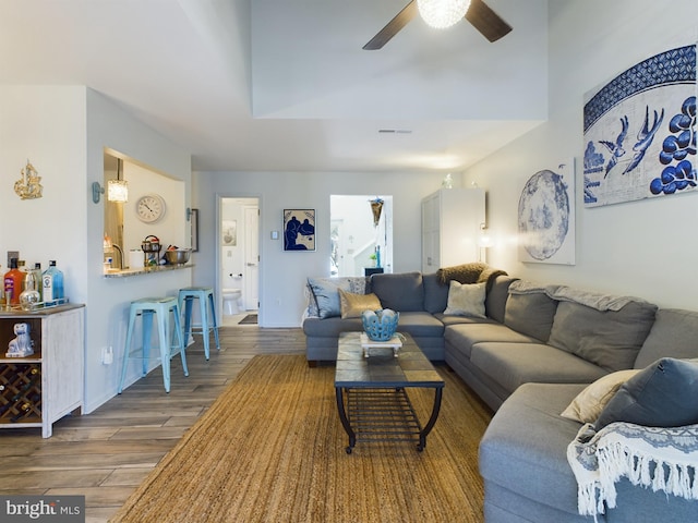 living room with ceiling fan and hardwood / wood-style flooring