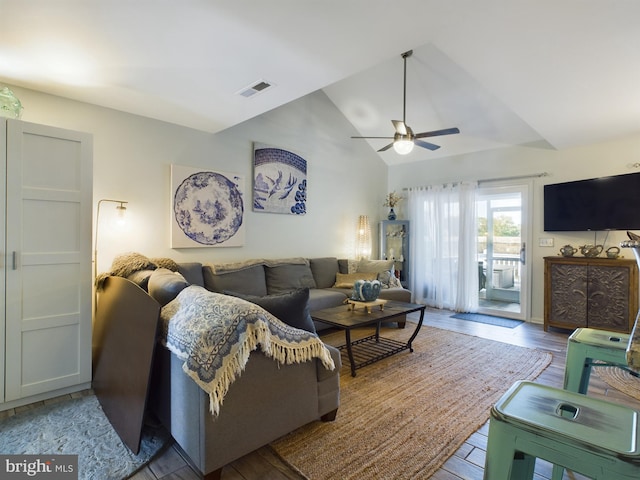 living room featuring light hardwood / wood-style flooring, vaulted ceiling, and ceiling fan