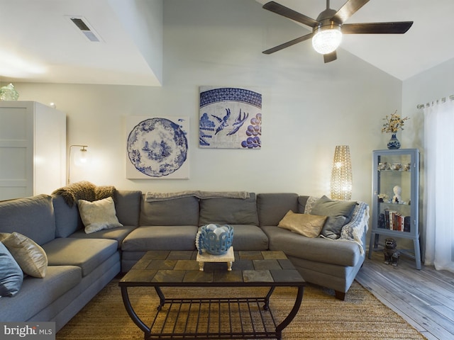 living room with wood-type flooring, lofted ceiling, and ceiling fan