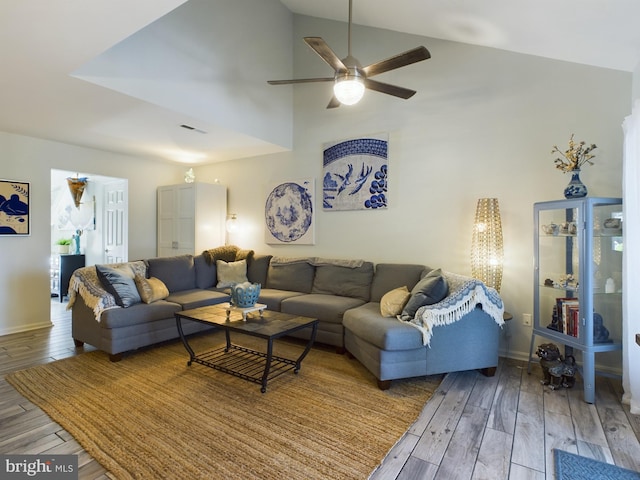 living room with wood-type flooring, lofted ceiling, and ceiling fan