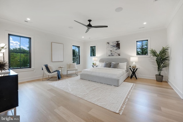 bedroom with ceiling fan, light hardwood / wood-style floors, and multiple windows