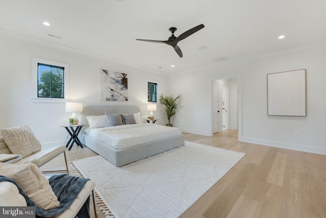 bedroom with ceiling fan, light hardwood / wood-style flooring, and crown molding