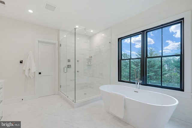 bathroom featuring vanity, separate shower and tub, and plenty of natural light