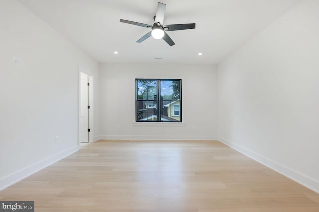 spare room featuring ceiling fan and light hardwood / wood-style flooring