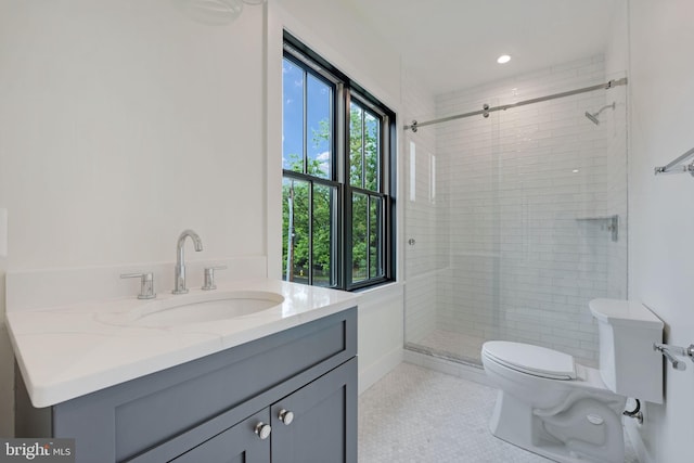 bathroom featuring vanity, toilet, an enclosed shower, and tile patterned floors