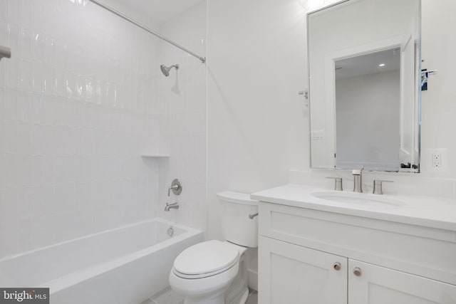 full bathroom with vanity, tiled shower / bath combo, and toilet