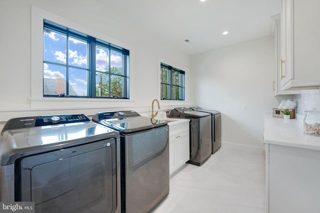 washroom with cabinets and independent washer and dryer