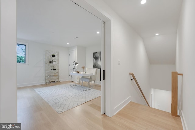 corridor with light wood-type flooring