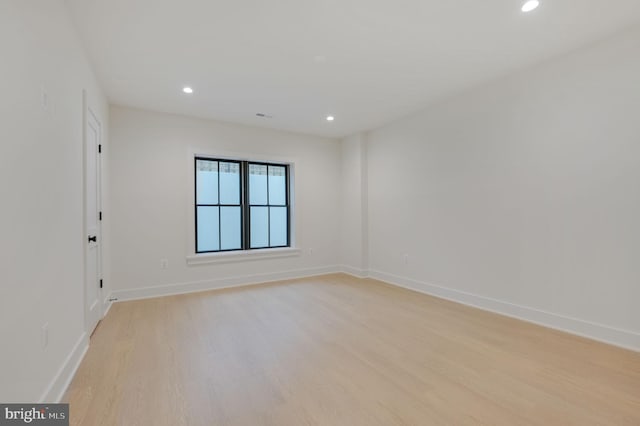 empty room with light hardwood / wood-style flooring