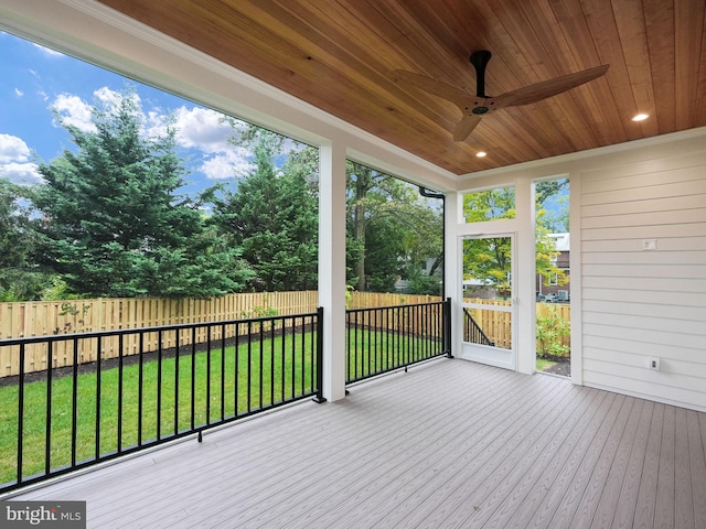 deck featuring ceiling fan and a lawn