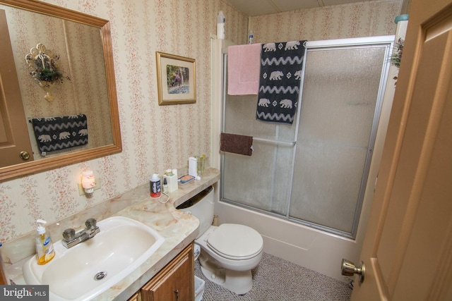 full bathroom with tile patterned flooring, vanity, toilet, and bath / shower combo with glass door