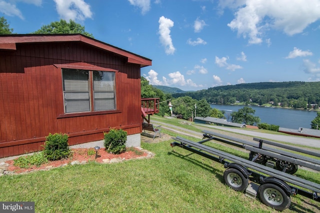 view of yard with a playground and a water and mountain view