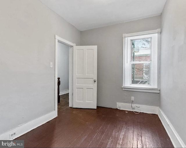 unfurnished bedroom with dark hardwood / wood-style floors