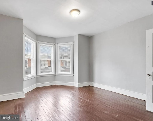 unfurnished room featuring dark wood-type flooring