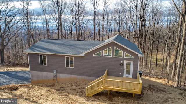 view of side of home featuring a wooden deck