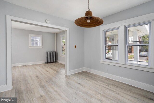 spare room with radiator and light hardwood / wood-style flooring