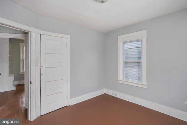 unfurnished room featuring dark hardwood / wood-style flooring