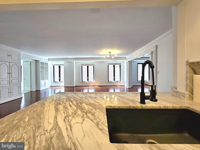 1080 Wisconsin Ave NW Unit 103/104, Washington, DC 20007 - living room with crown molding, decorative columns, baseboards, and dark wood finished floors