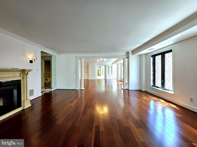 1080 Wisconsin Ave NW Unit 103/104, Washington, DC 20007 - unfurnished living room with crown molding, decorative columns, a fireplace, baseboards, and dark wood finished floors