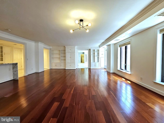 1080 Wisconsin Ave NW Unit 103/104, Washington, DC 20007 - unfurnished living room featuring ornamental molding, built in features, baseboards, a chandelier, and dark wood finished floors