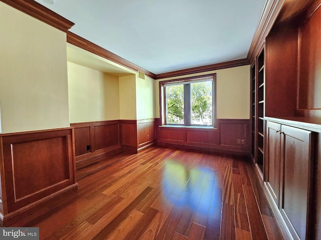 1080 Wisconsin Ave NW Unit 103/104, Washington, DC 20007 - spare room featuring dark wood-style floors, ornamental molding, and a wainscoted wall