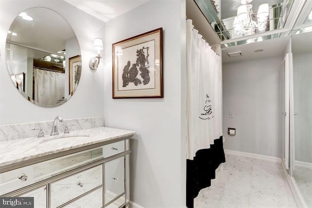 bathroom with walk in shower and vanity