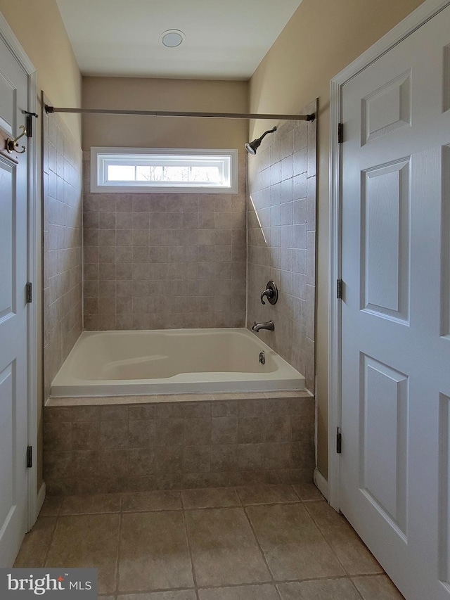 bathroom featuring tile patterned floors and tiled shower / bath combo