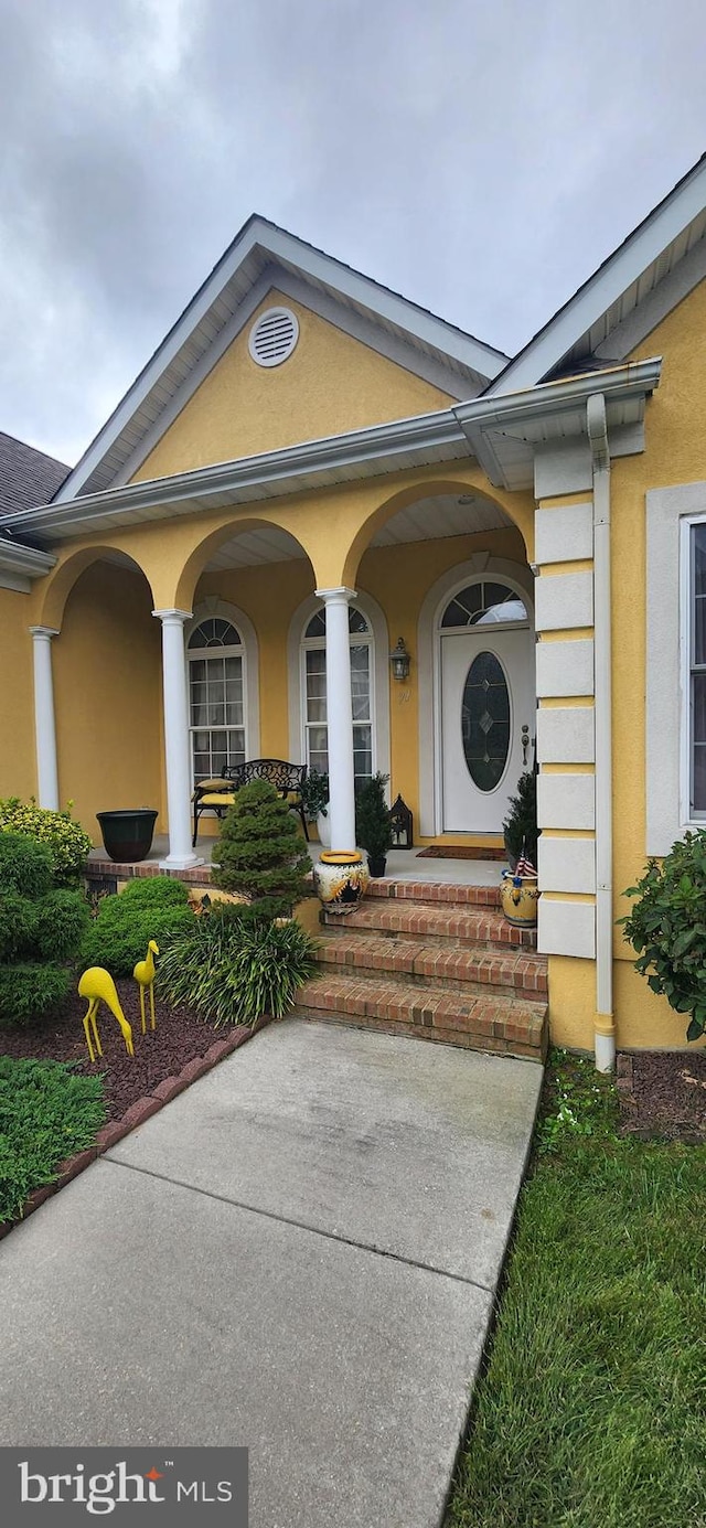 view of exterior entry featuring a porch