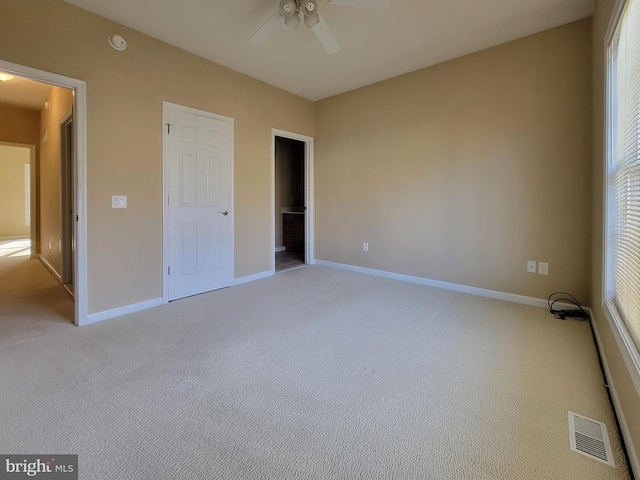 unfurnished bedroom featuring ceiling fan and light colored carpet