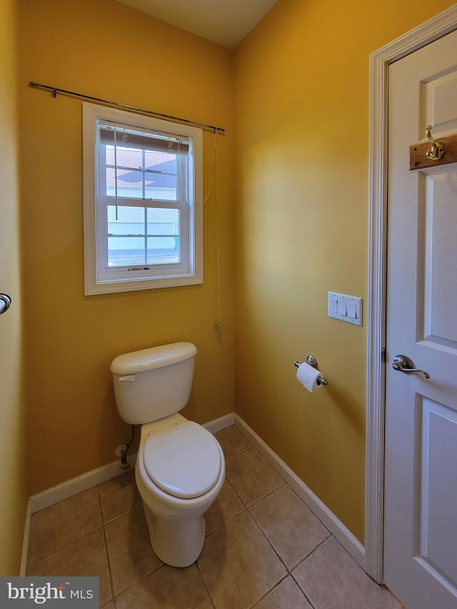 bathroom featuring tile patterned flooring and toilet