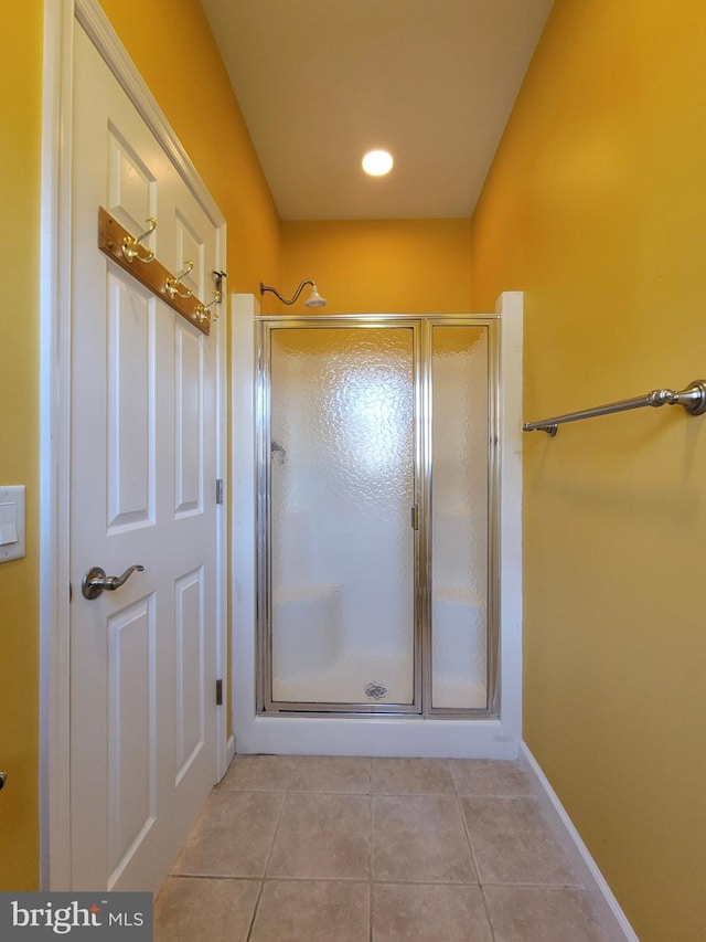 bathroom featuring tile patterned floors and a shower with shower door