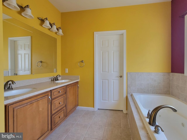 bathroom with tile patterned flooring, vanity, and tiled tub