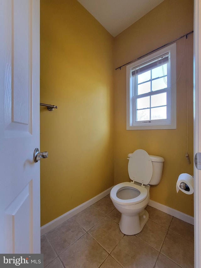 bathroom with tile patterned flooring and toilet