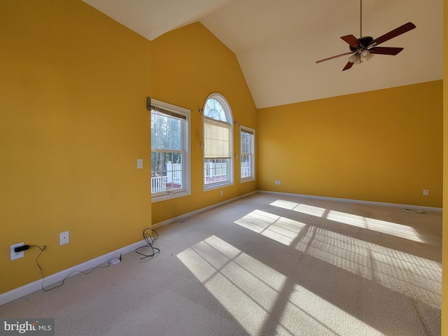 carpeted spare room featuring ceiling fan and vaulted ceiling