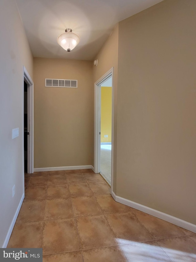 hall featuring light tile patterned floors