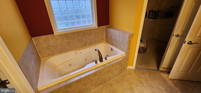 bathroom with tile patterned floors and tiled bath