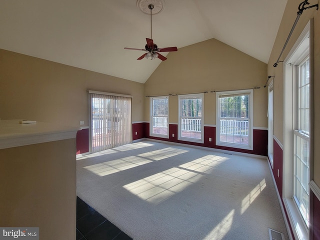 unfurnished sunroom featuring ceiling fan and lofted ceiling