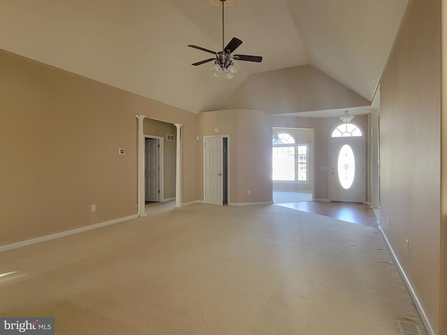 unfurnished living room featuring ceiling fan, high vaulted ceiling, and light colored carpet