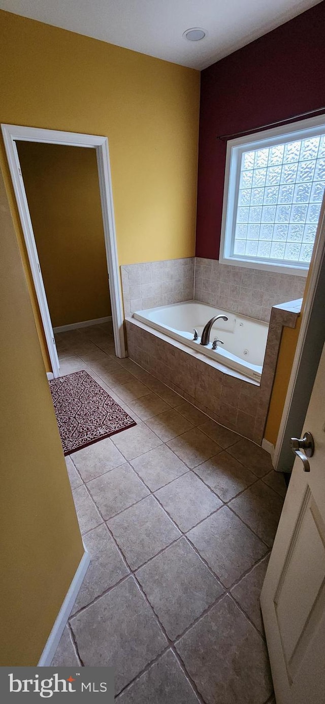 bathroom featuring tile patterned floors and tiled tub