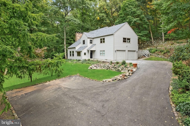 view of front of property featuring a garage and a front yard