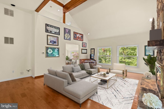 living room featuring beamed ceiling, hardwood / wood-style flooring, and high vaulted ceiling