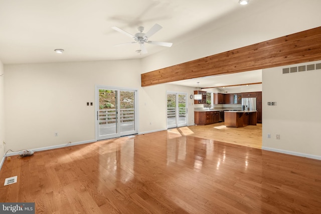 unfurnished living room featuring high vaulted ceiling, ceiling fan, and light hardwood / wood-style floors