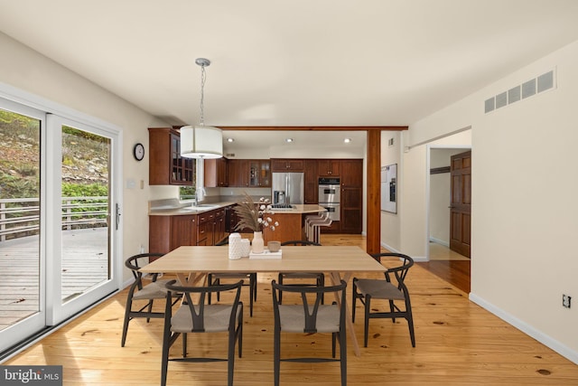 dining area featuring light hardwood / wood-style flooring and sink