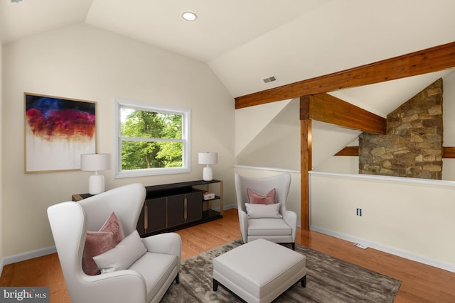 sitting room featuring wood-type flooring and vaulted ceiling