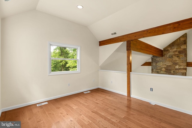 bonus room featuring lofted ceiling and light hardwood / wood-style floors