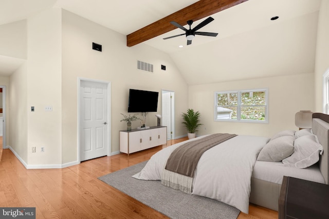 bedroom with ceiling fan, beamed ceiling, light hardwood / wood-style flooring, and high vaulted ceiling