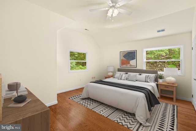 bedroom featuring ceiling fan, vaulted ceiling, and wood-type flooring